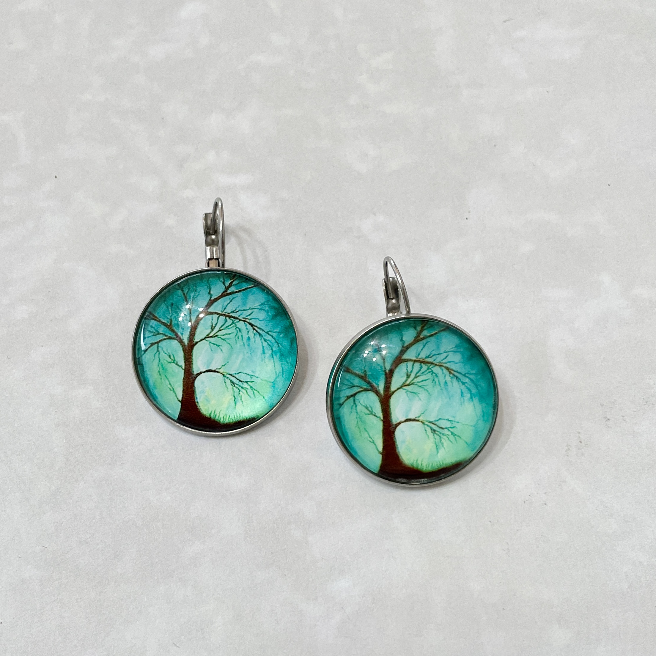 Pair of round tree silhouette turquoise earrings