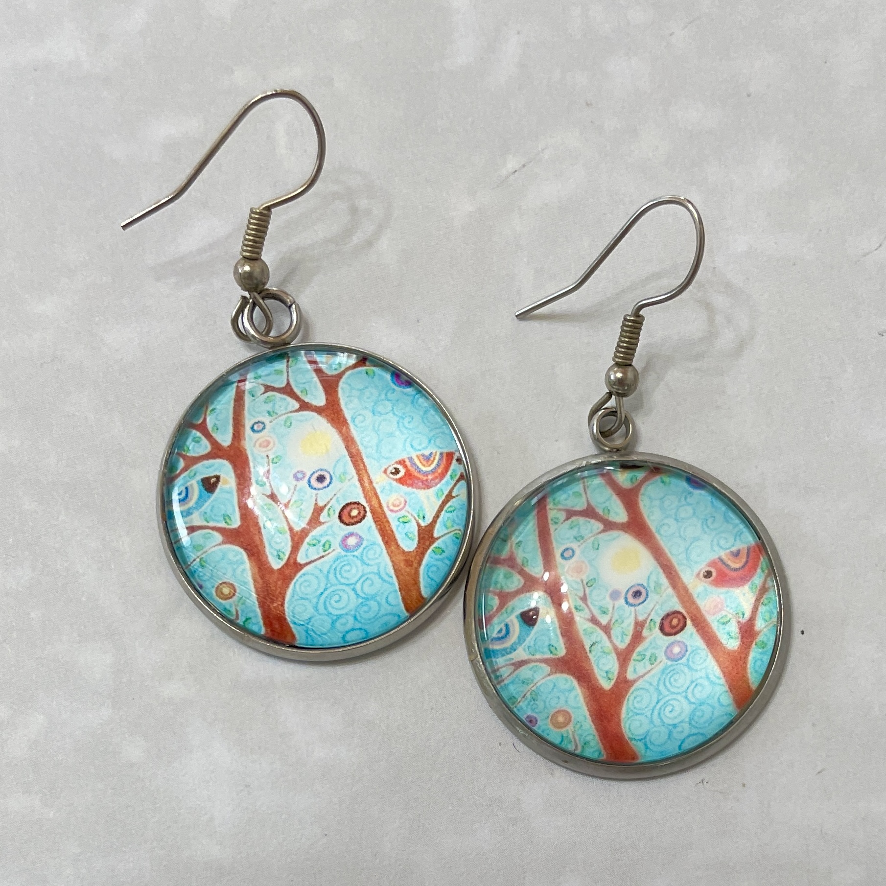 Round turquoise tree and bird dangle earrings