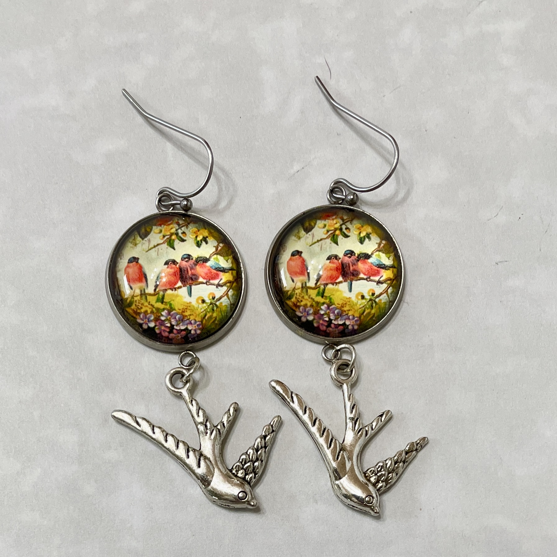 Bird-themed dangle earrings with silver swallow charms