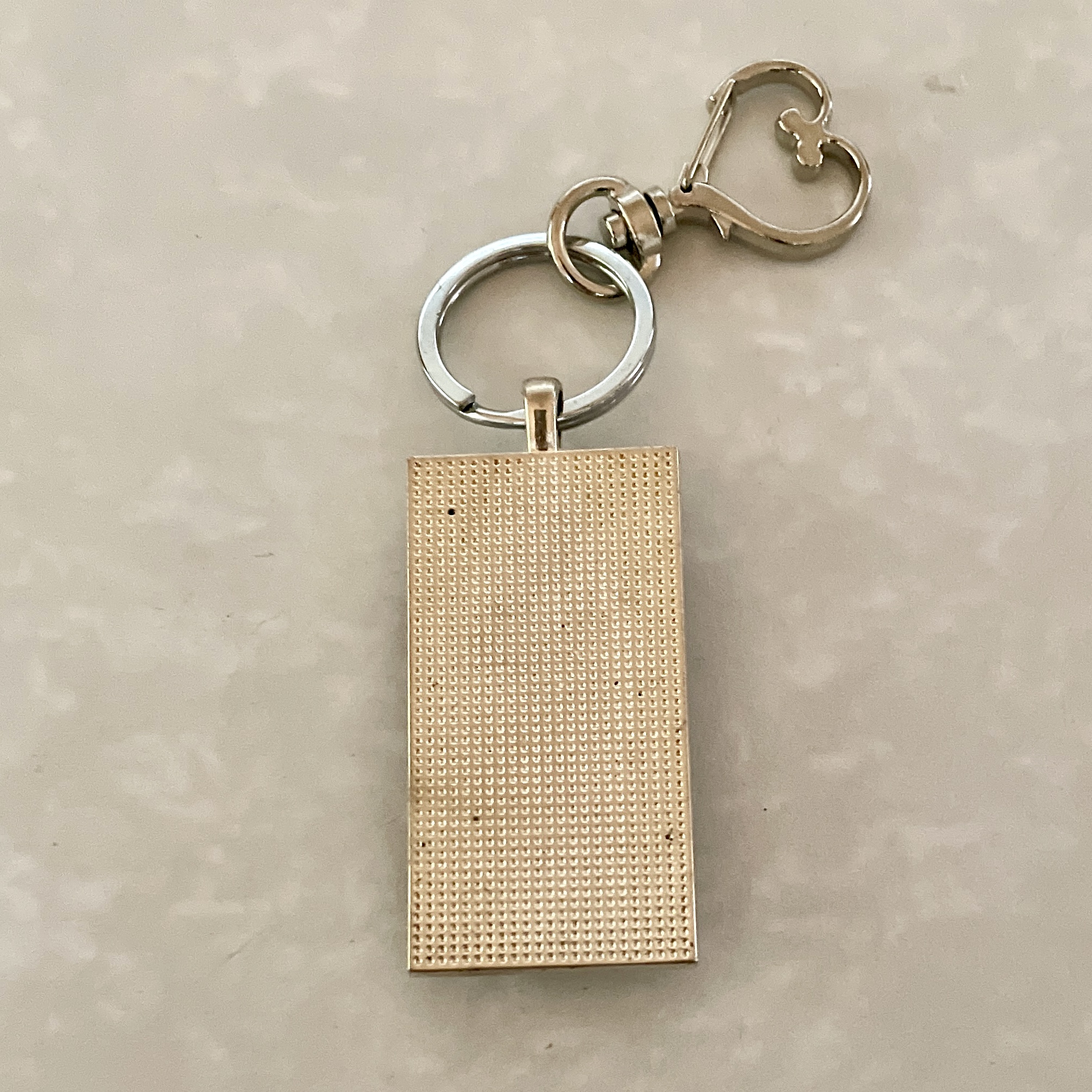 Gold rectangular textured keychain with heart clasp