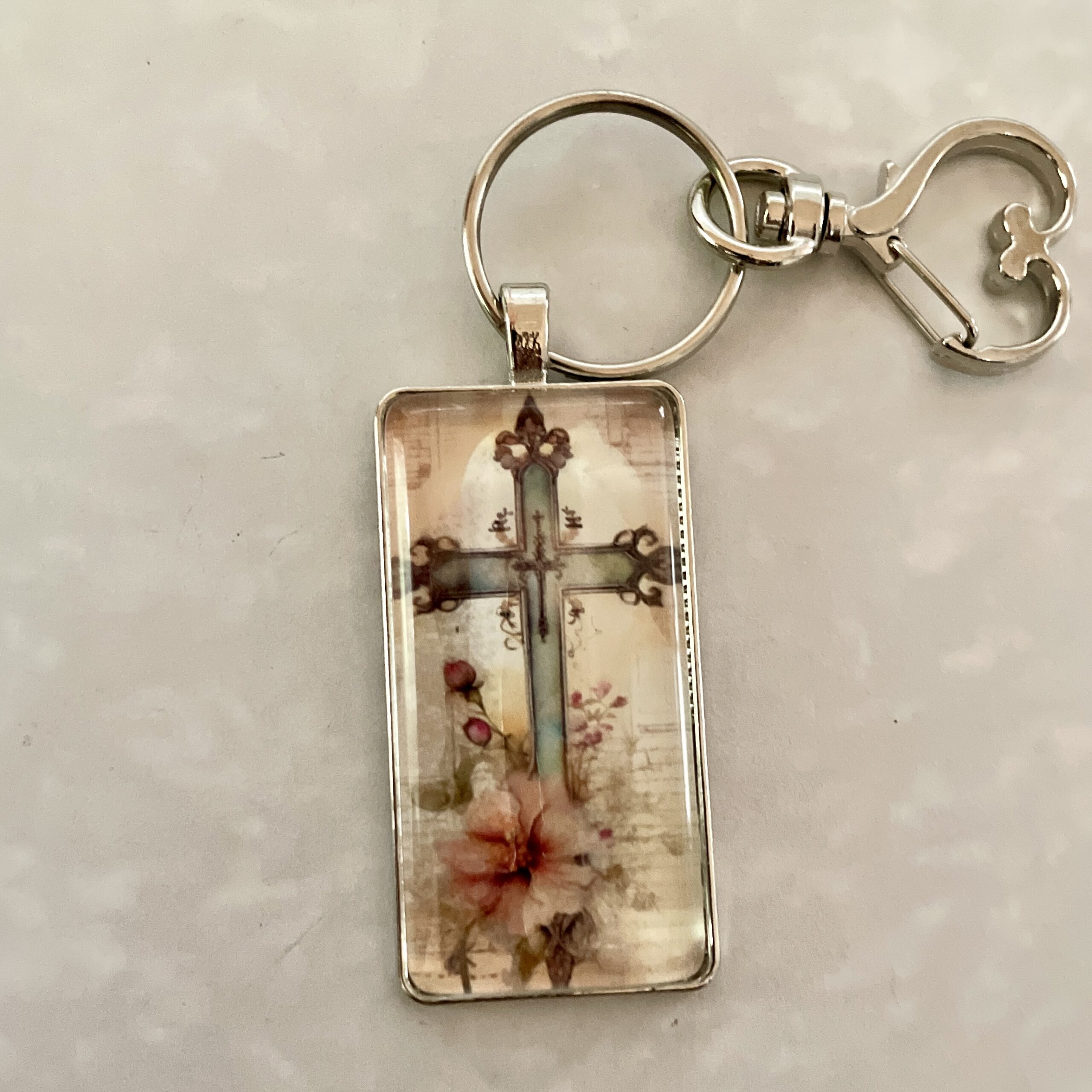 Rectangular keychain pendant with floral cross