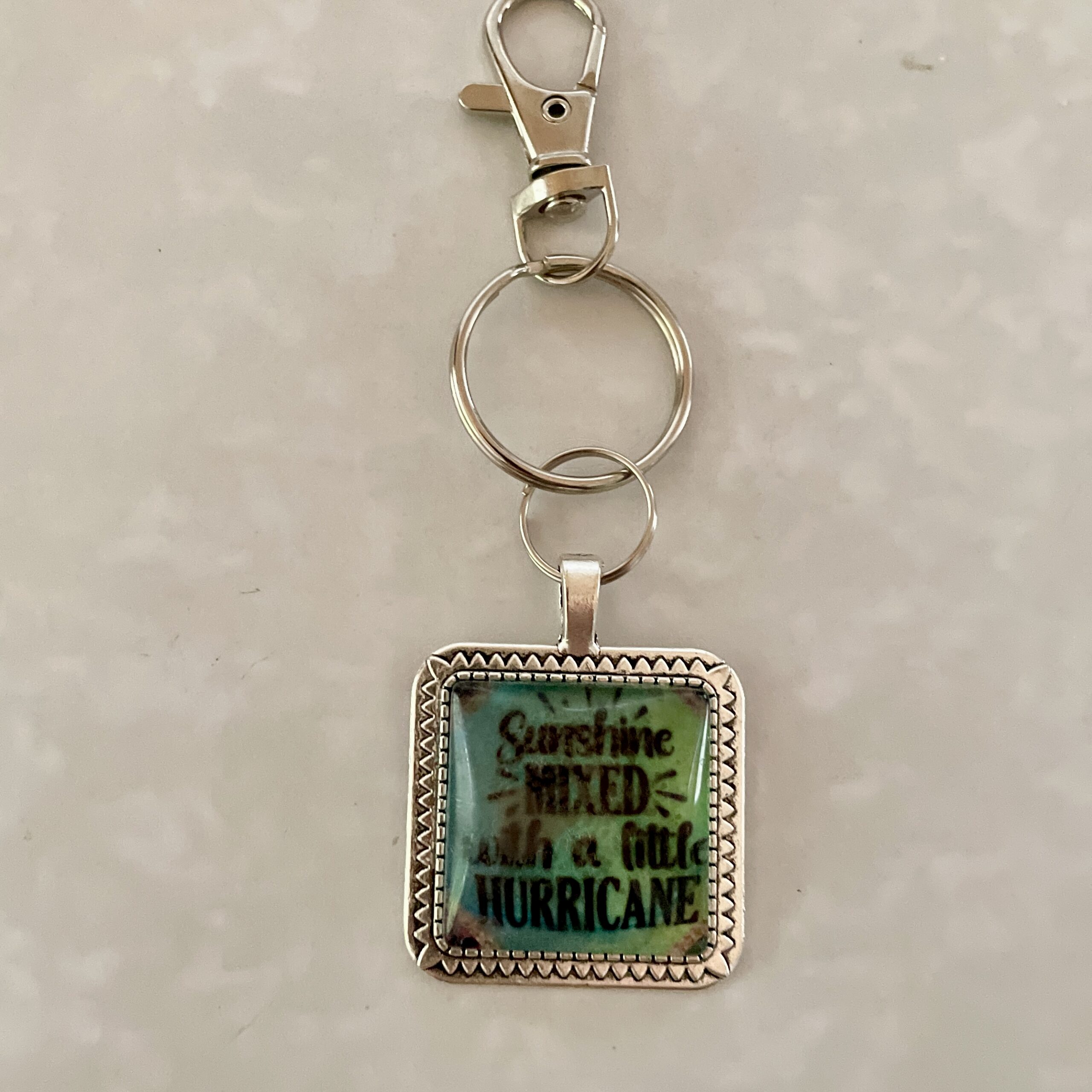 Keychain reading "Sunshine mixed with a little hurricane
