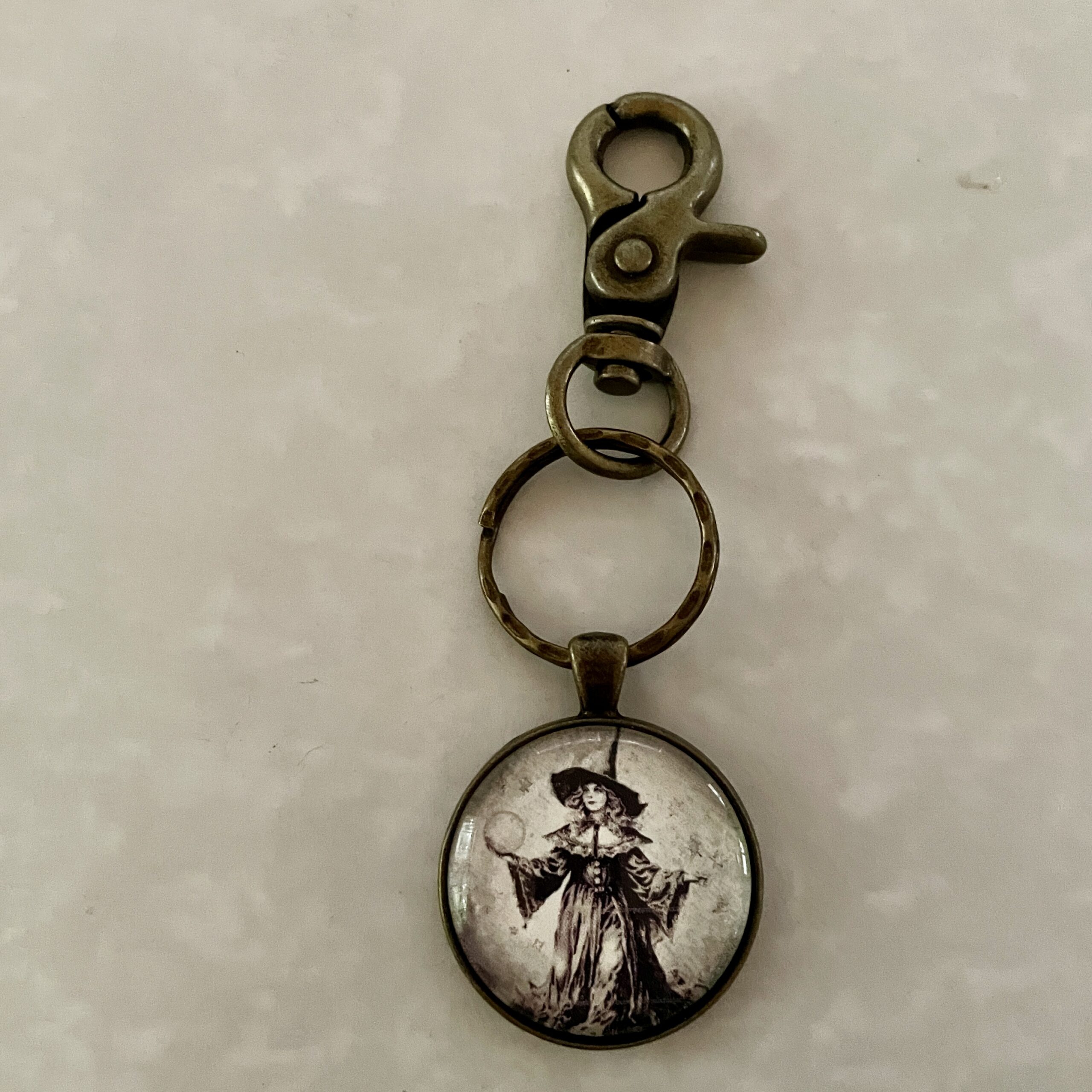 Antique brass keychain with witch pendant