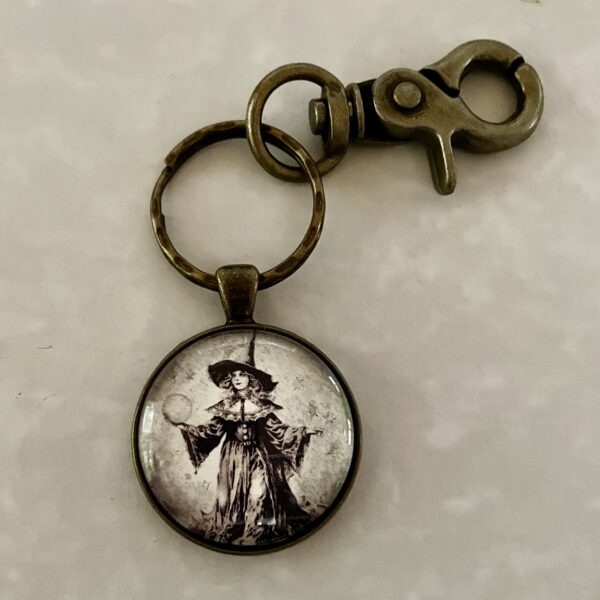 Brass keychain pendant featuring vintage witch