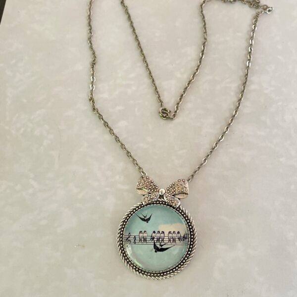 Silver round pendant necklace with birds silhouette