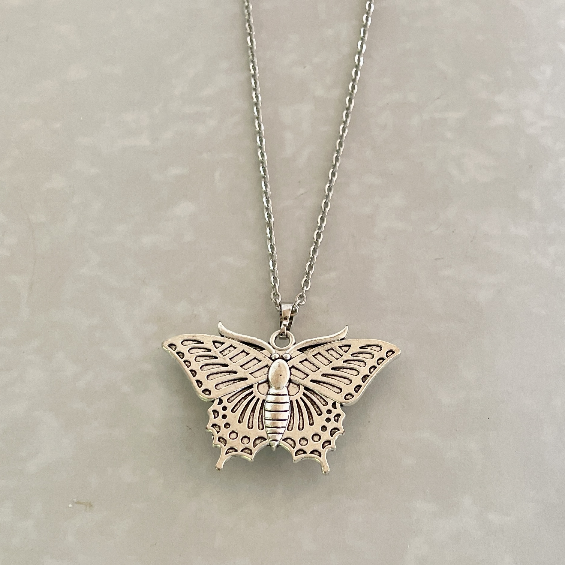 Silver butterfly pendant necklace on chain