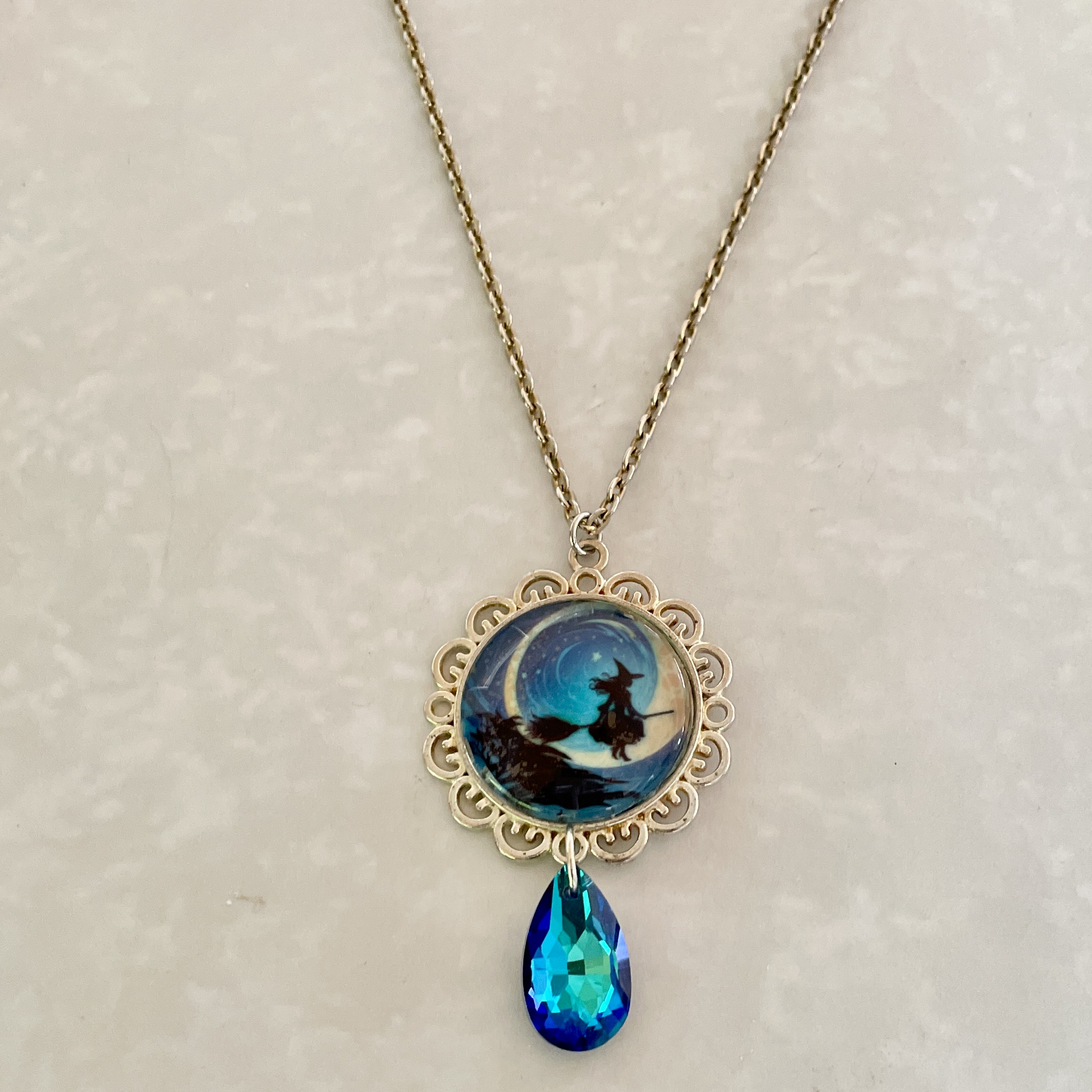 Gold necklace with witch moon and blue teardrop
