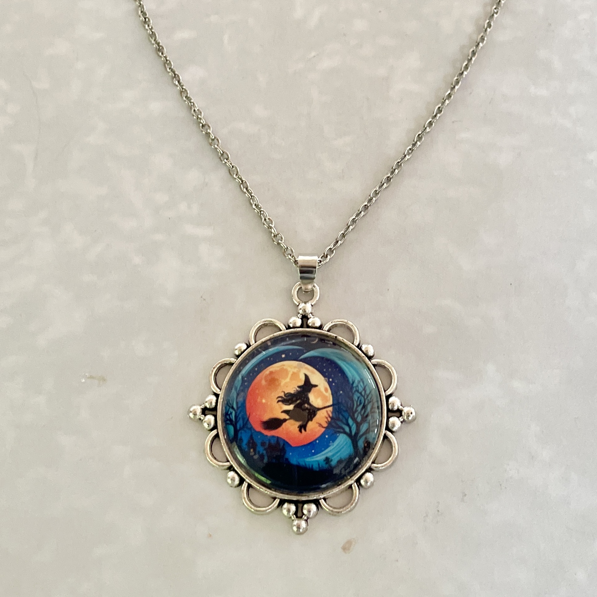 Silver pendant necklace with witch moon design