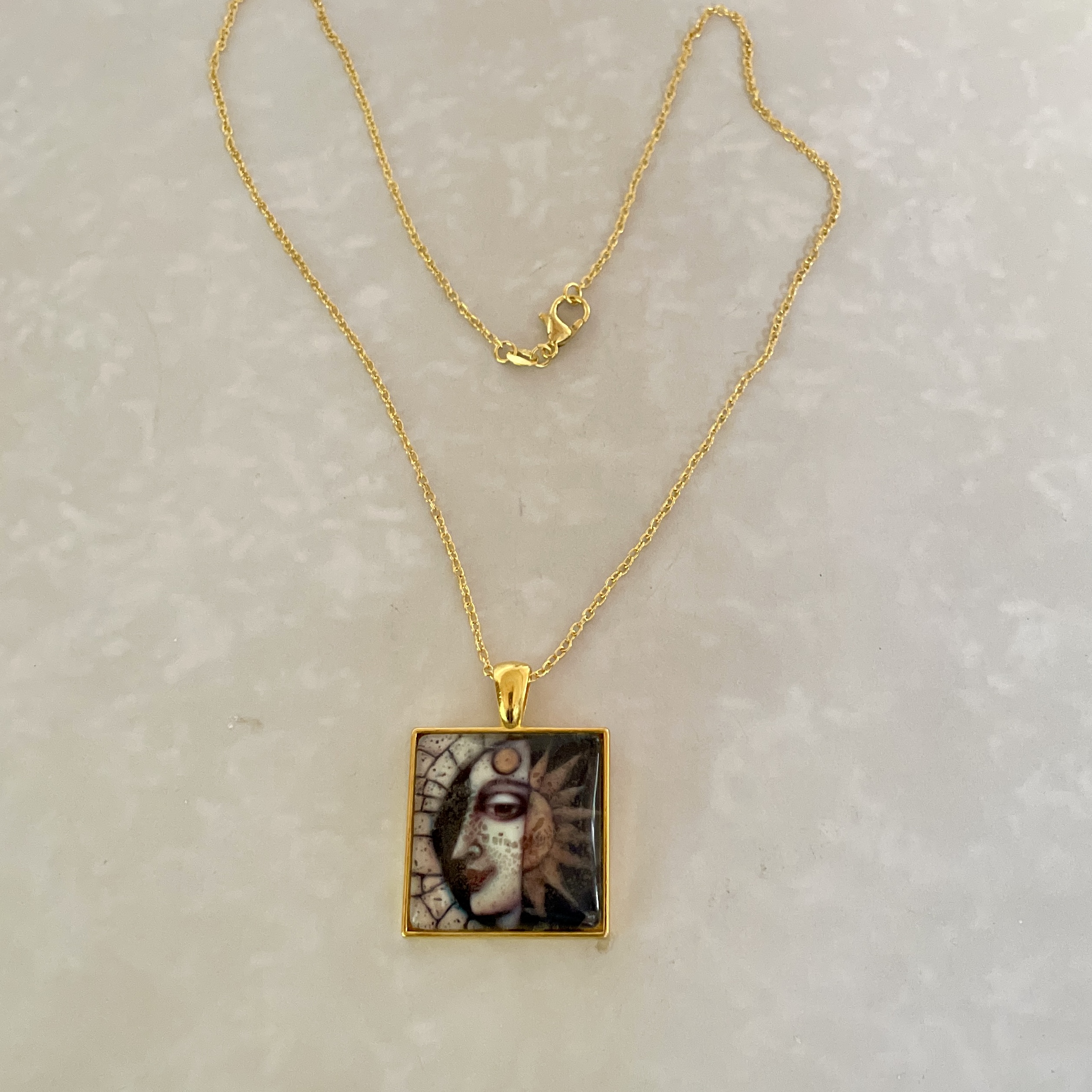 Gold chain with sun-and-moon square pendant