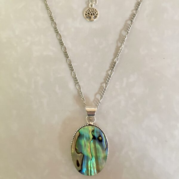 Silver necklace featuring an iridescent pendant.