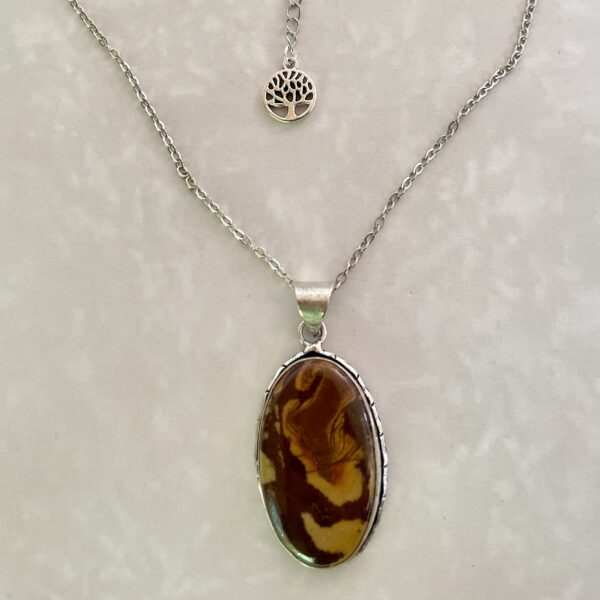 "Silver necklace with marbled brown stone pendant."