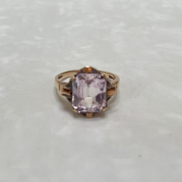 Elegant rose gold ring with pink gemstone.
