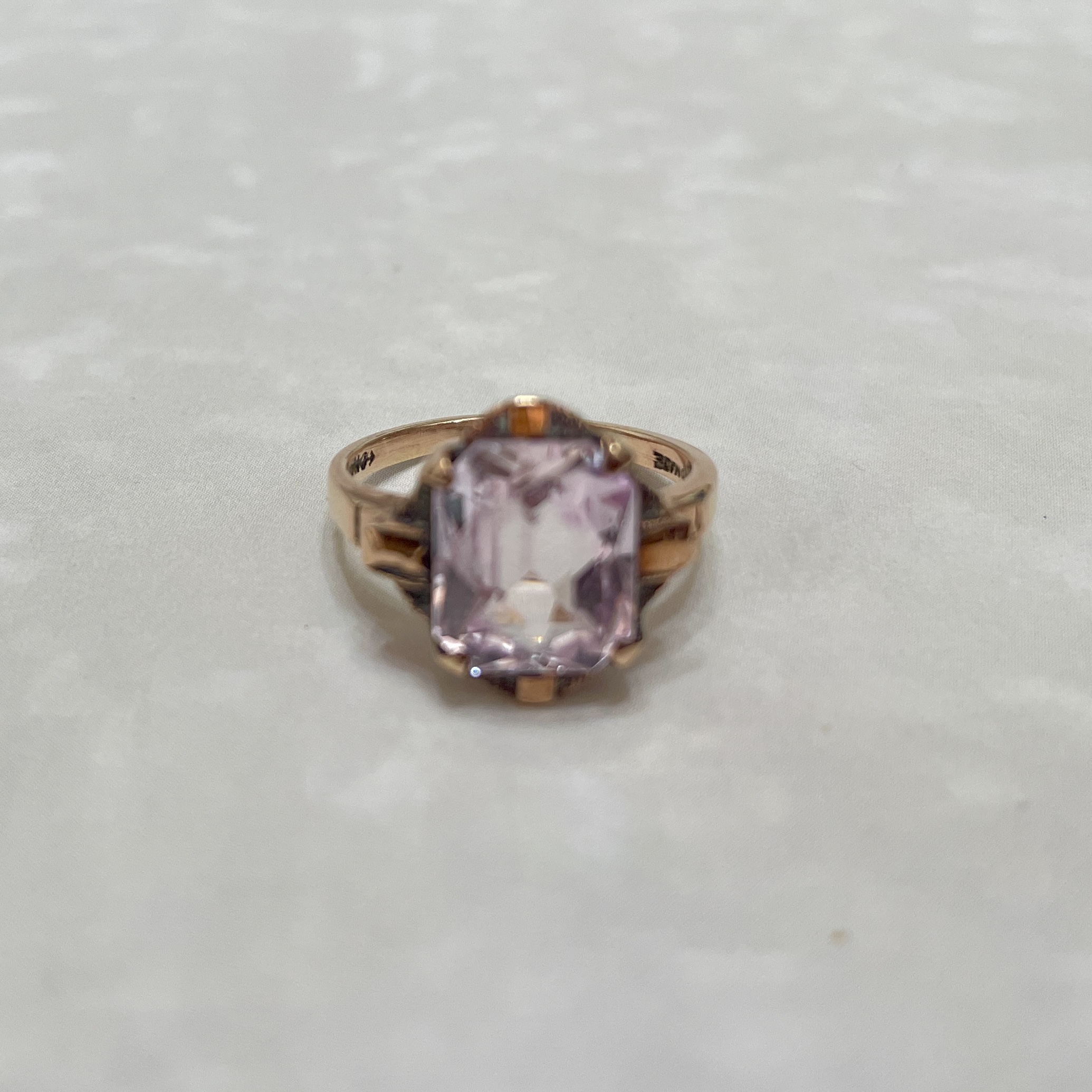 Elegant rose gold ring with pink gemstone.