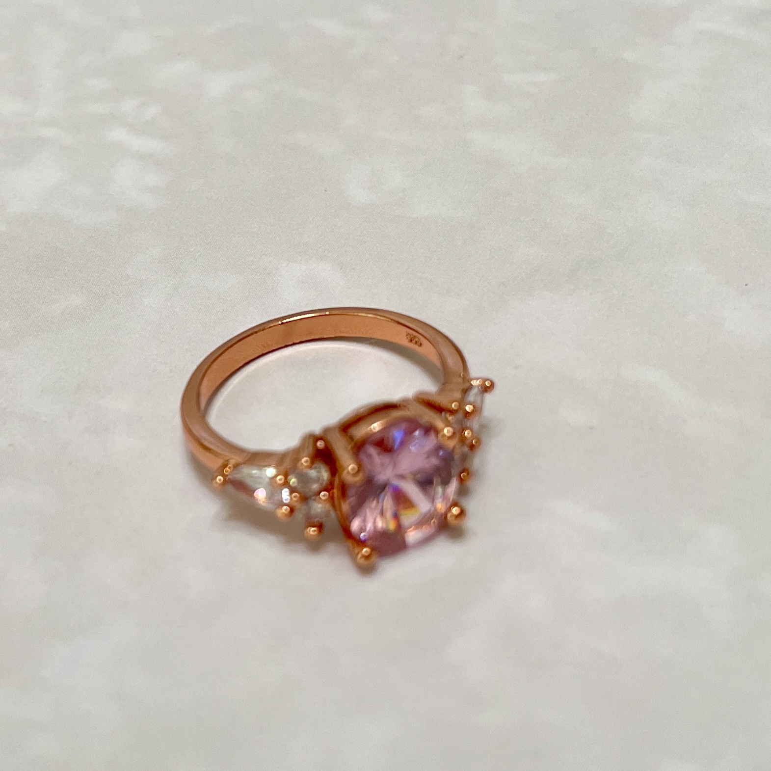 Rose gold ring featuring a pink gemstone.