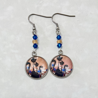 Round floral silhouette dangle earrings with blue beads