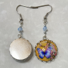 Mismatched earrings: purple pansy resin and silver disk
