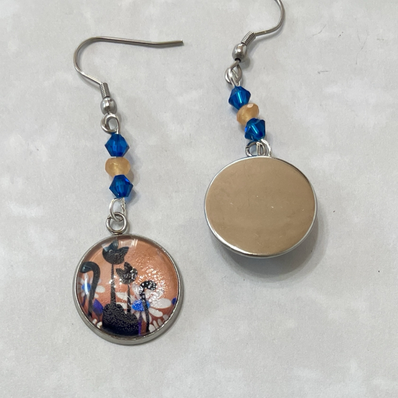 Silver dangle earrings with round floral pendants