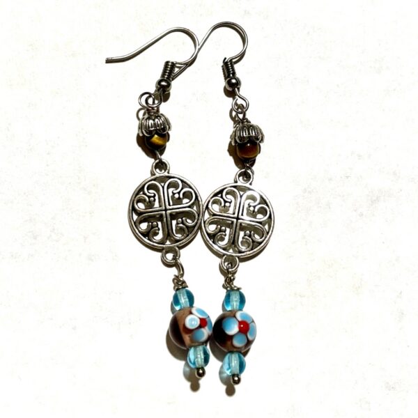 Colorful earrings with intricate silver designs.