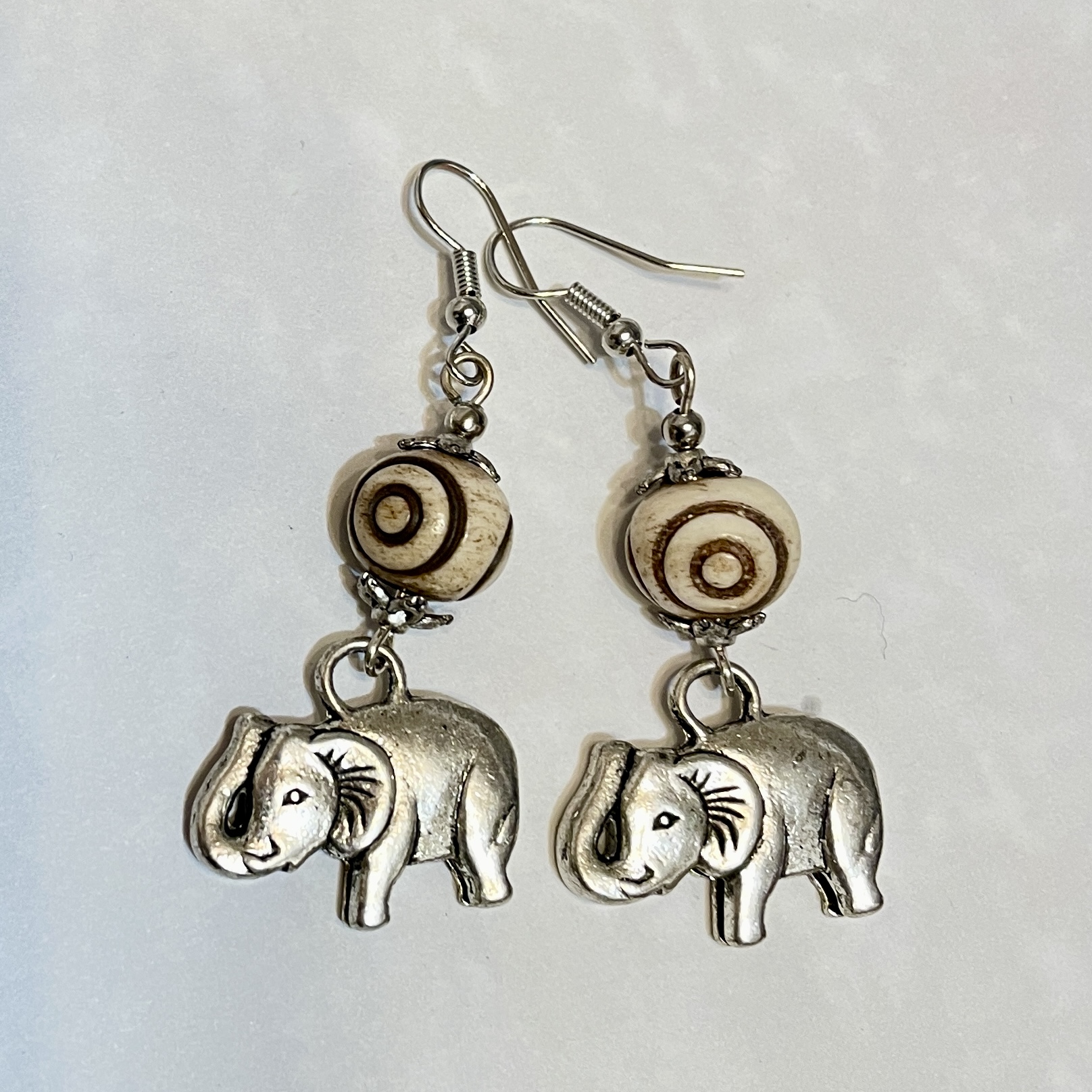 Elephant earrings with decorative wooden beads.