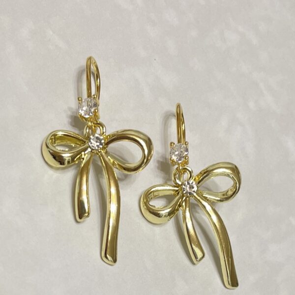 Gold bow earrings with sparkling crystal accents.