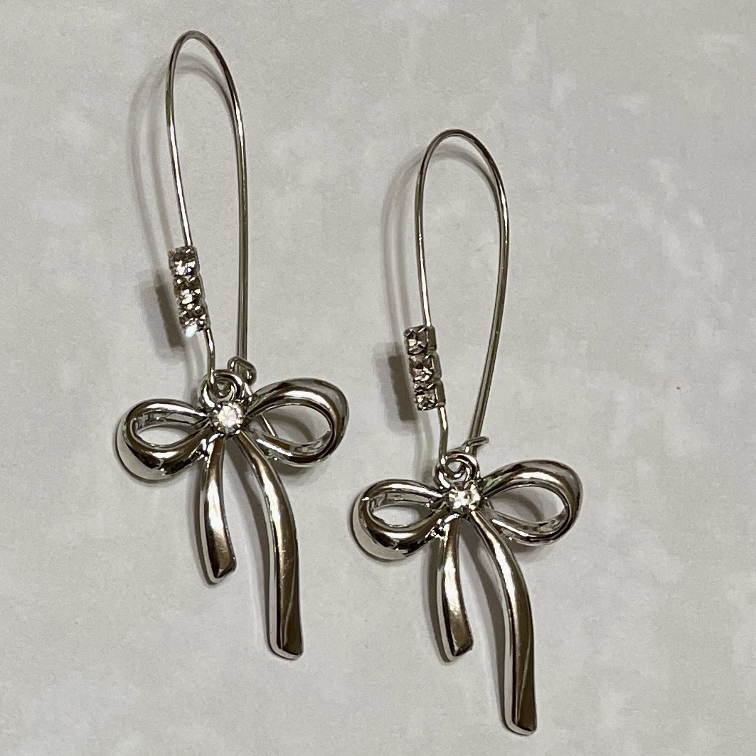Shiny silver earrings with bow design.