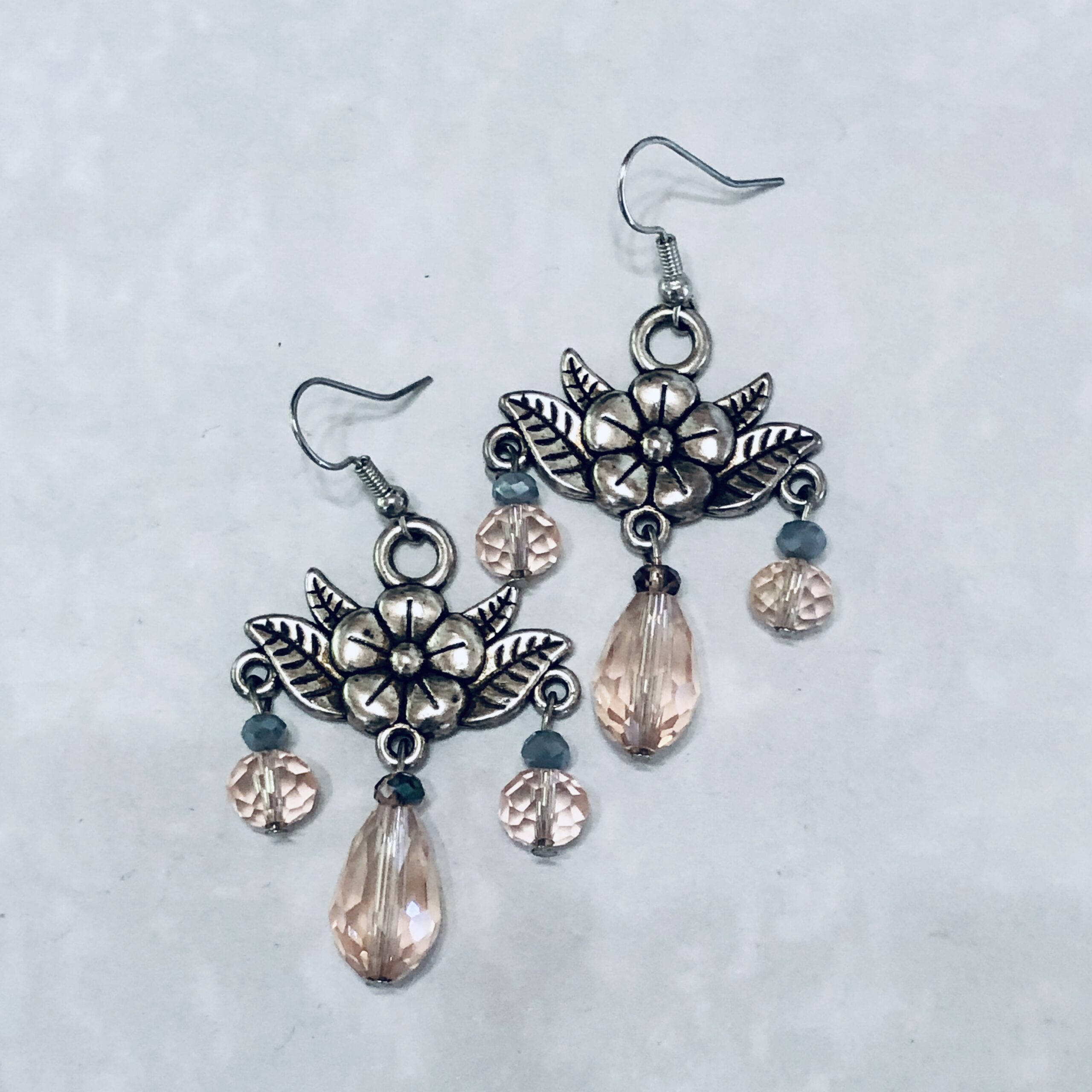 Floral earrings with pink crystals and silver accents.