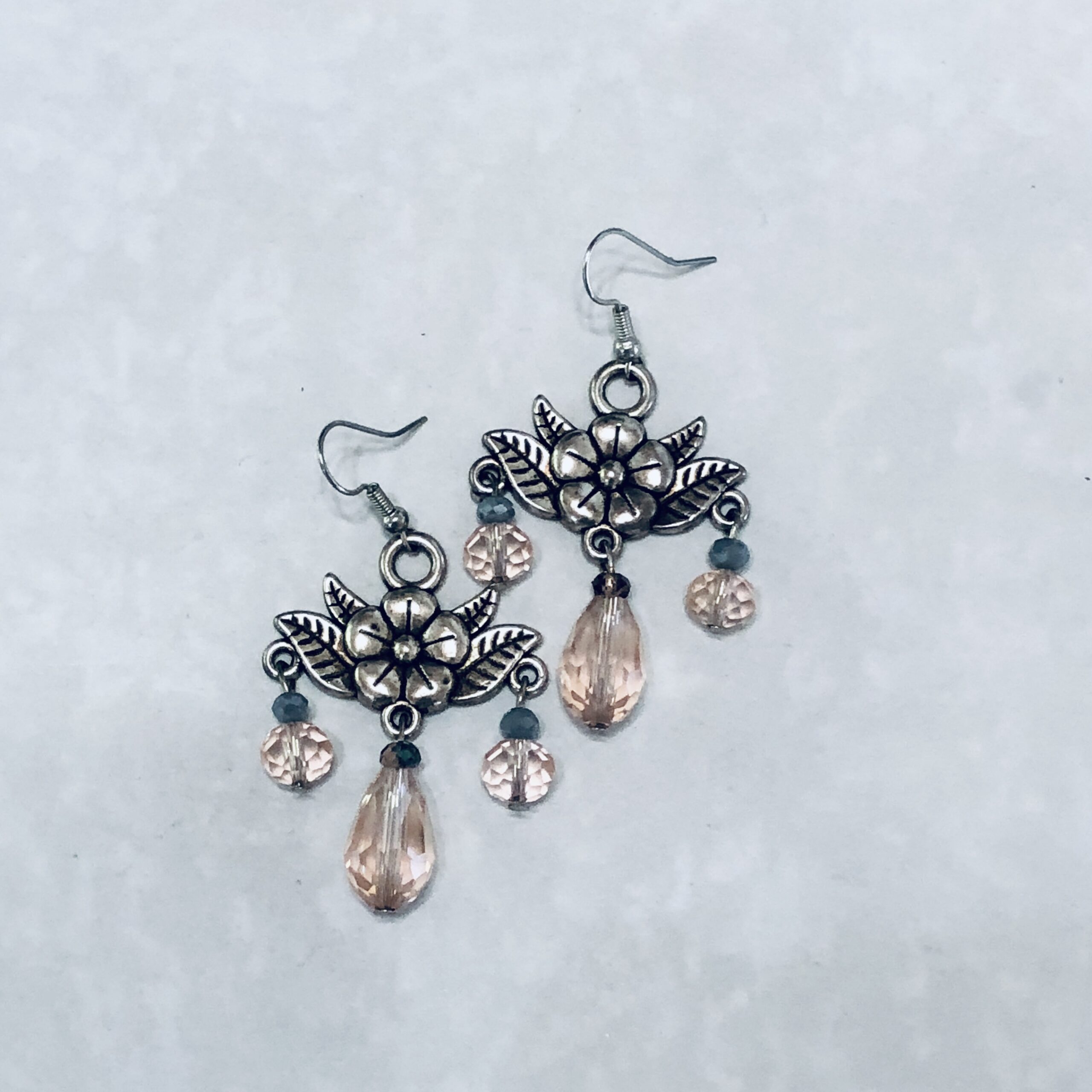 Delicate earrings with floral design and crystals.