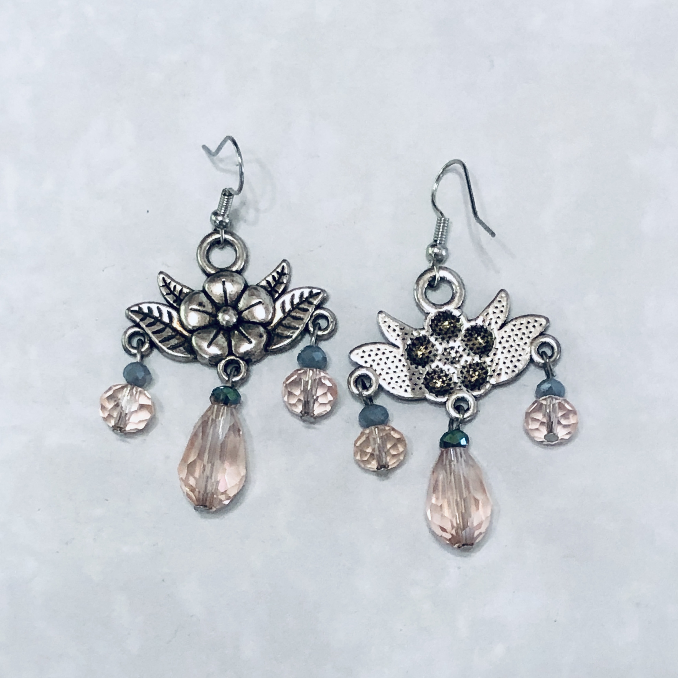 Floral earrings with pink crystal accents.