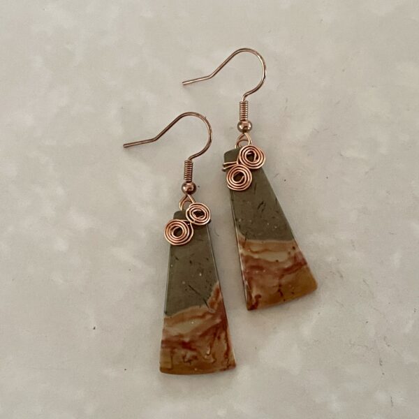 "Geometric stone earrings with copper accents."