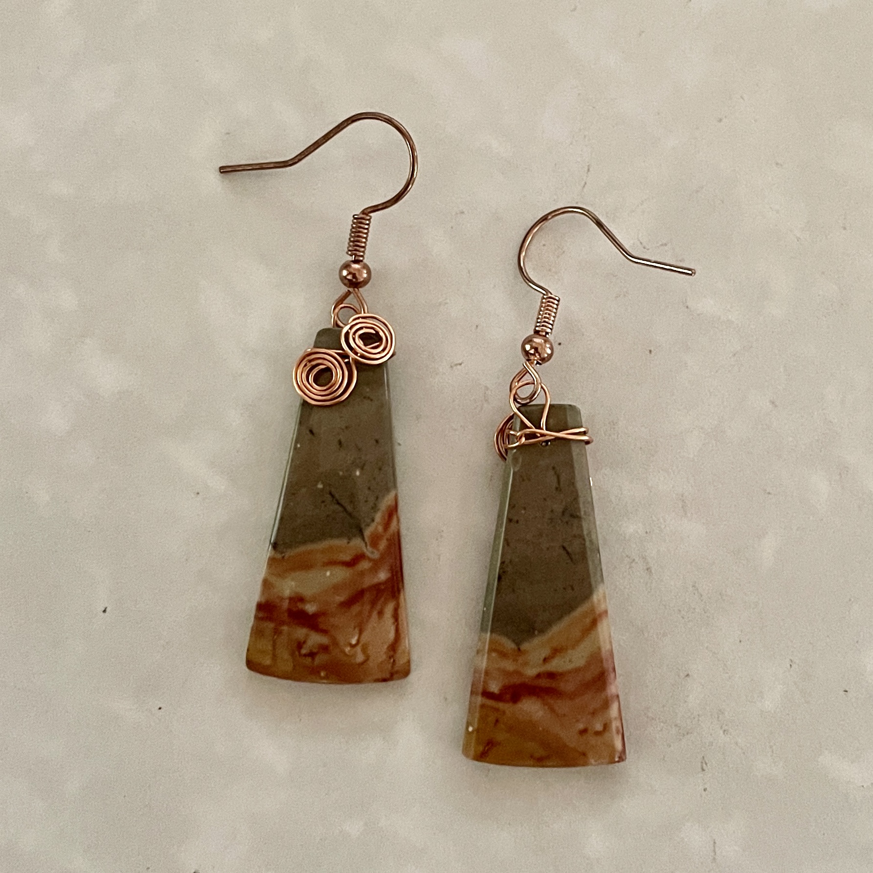 Unique triangular earrings with copper accents.